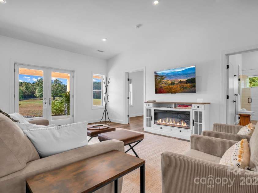 1260 Beaver Island Trail Road, Walnut Cove, NC 27052.  MLS# CAR4325171, YatesRealty ID 2036. Living room w/ built in electric fireplace cabinet, LVP flooring throughout, and cathedral ceilings