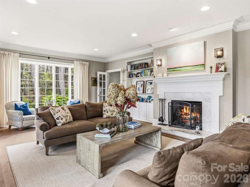 10 Kalimar Heights, Hendersonville, NC 28739.  MLS# CAR4376746, YatesRealty ID 20362. Spacious front living room with built-ins, original windows, and wood burning fireplace.  This room opens out to the front terrace.