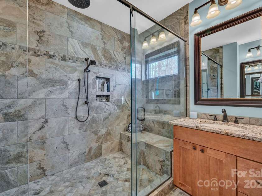 146 Sarinac Drive, Bostic, NC 28018.  MLS# CAR4327091, YatesRealty ID 2037. Ensuite bathroom with large tiled walk in shower, water closet w/bidet and granite countertops