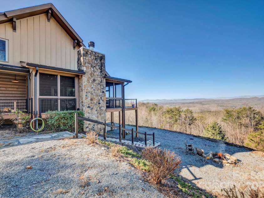 146 Sarinac Drive, Bostic, NC 28018.  MLS# CAR4327091, YatesRealty ID 2037. Side yard stairs accesses the firepit, lower property and patio area under upper deck