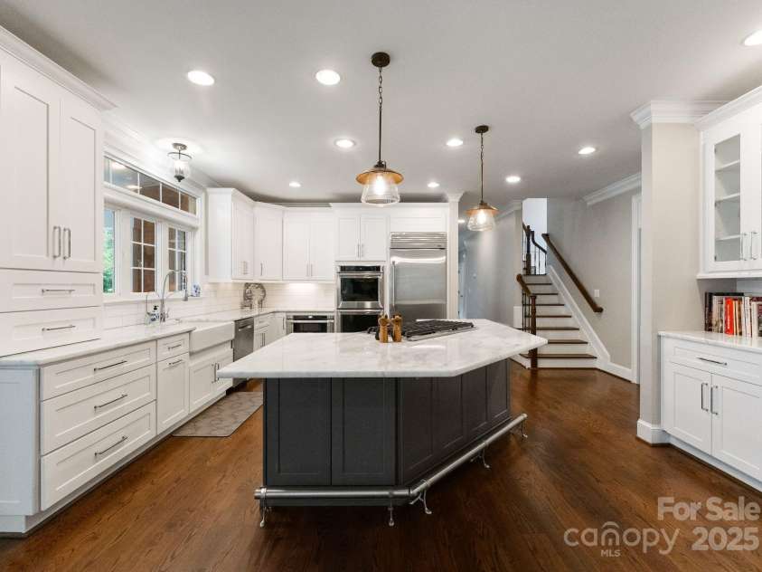 239 Kimberly Road, Davidson, NC 28036.  MLS# CAR4288776, YatesRealty ID 2038. Bright Kitchen is open to the Keeping Room with a fireplace!