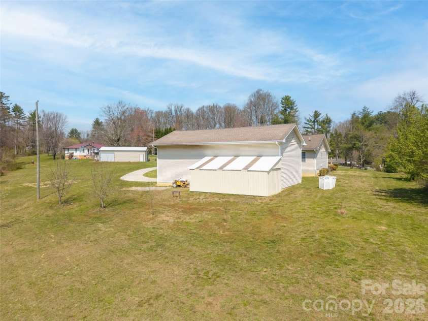 476 Jackson Loop Road, Flat Rock, NC 28731.  MLS# CAR4363362, YatesRealty ID 20386. Back yard behind work shop