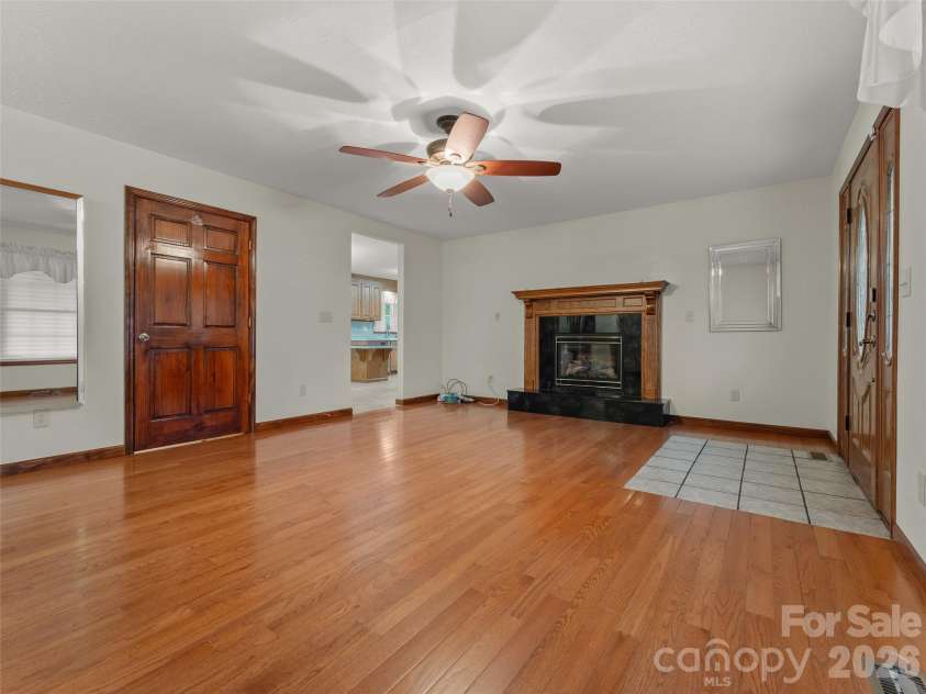 476 Jackson Loop Road, Flat Rock, NC 28731.  MLS# CAR4363362, YatesRealty ID 20386. Living Room w/ Fireplace