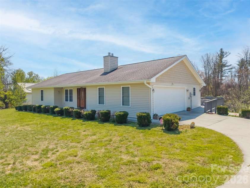 476 Jackson Loop Road, Flat Rock, NC 28731.  MLS# CAR4363362, YatesRealty ID 20386. Side with garage and driveway