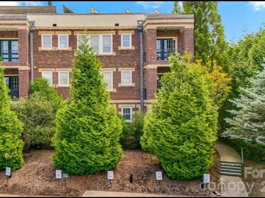203 6th Avenue, Hendersonville, NC 28739.  MLS# CAR4288242, YatesRealty ID 2039. The condo is on the main floor and has the two outdoor sitting areas as well as access to the building's rooftop terrace.