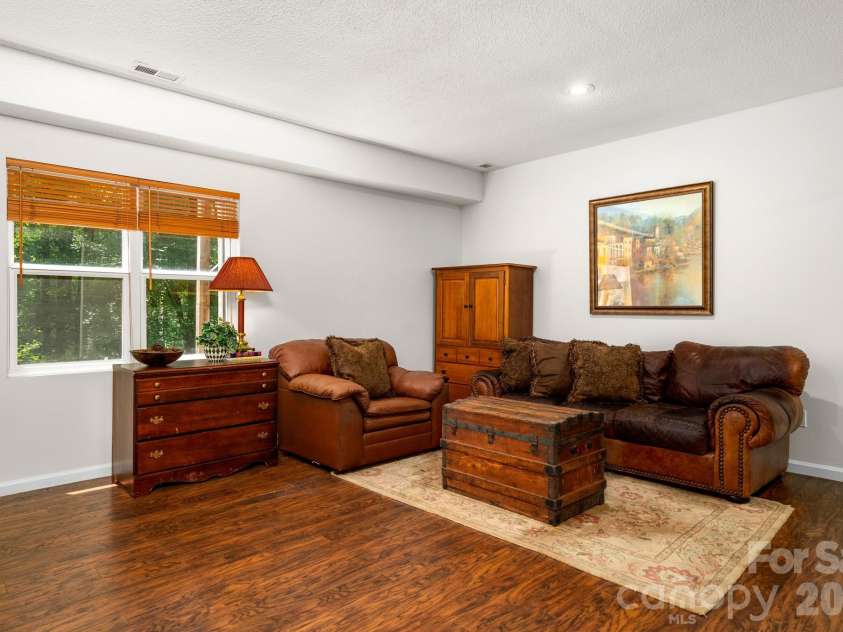 701 Salisbury Road, Hendersonville, NC 28792.  MLS# CAR4279569, YatesRealty ID 2040. Lower Level Living Room