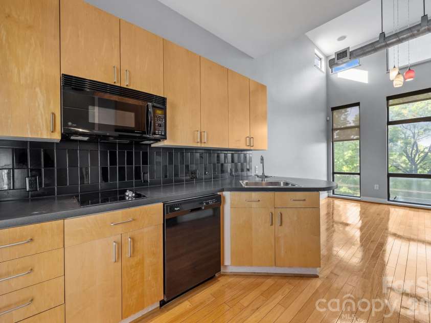 514 10th Street, Charlotte, NC 28202.  MLS# CAR4366152, YatesRealty ID 20407. Modern kitchen featuring wood cabinetry and stainless steel appliances.
