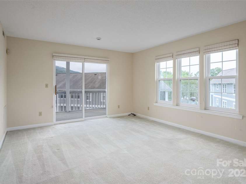 4805 Breakers Lane, Asheville, NC 28806.  MLS# CAR4307390, YatesRealty ID 2041. Living / Family room with entrance to screened, covered back porch sitting area.