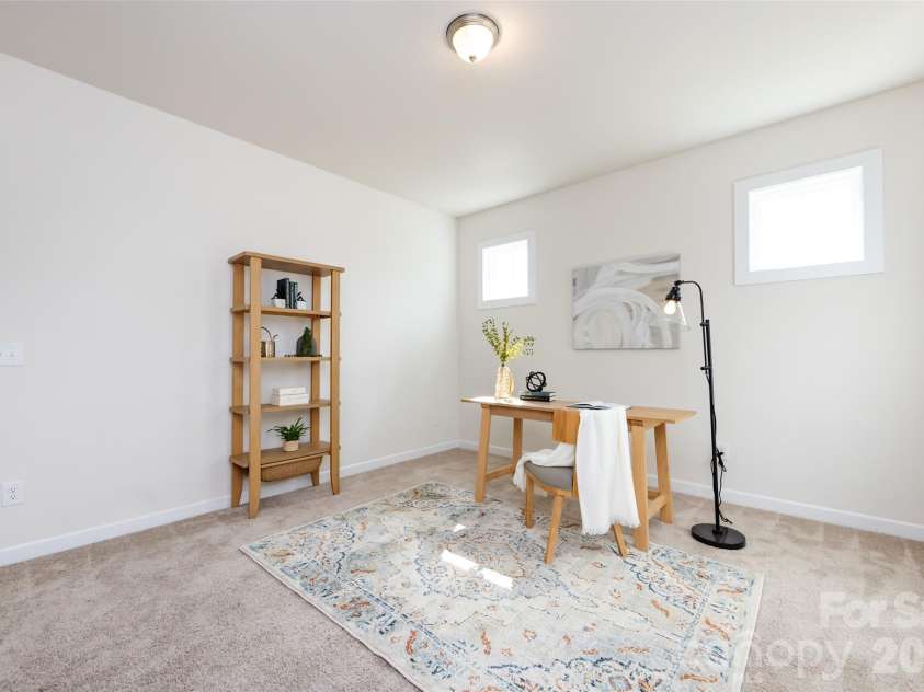 11440 Westbranch Parkway, Davidson, NC 28036.  MLS# CAR4366825, YatesRealty ID 20419. A versatile office space framed by elegant columns, offering a bright and functional work-from-home area.