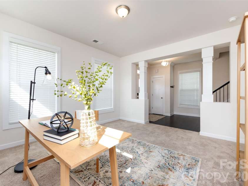 11440 Westbranch Parkway, Davidson, NC 28036.  MLS# CAR4366825, YatesRealty ID 20419. A versatile office space framed by elegant columns, offering a bright and functional work-from-home area.