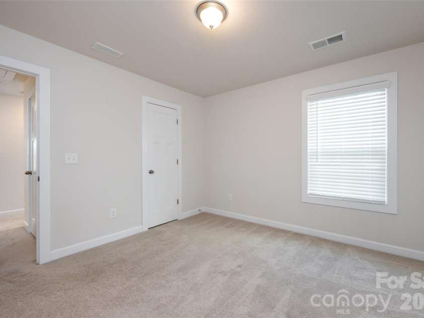 11440 Westbranch Parkway, Davidson, NC 28036.  MLS# CAR4366825, YatesRealty ID 20419. Comfortable third bedroom with soft carpeting, natural light, and a versatile layout ideal for guests or a home office.