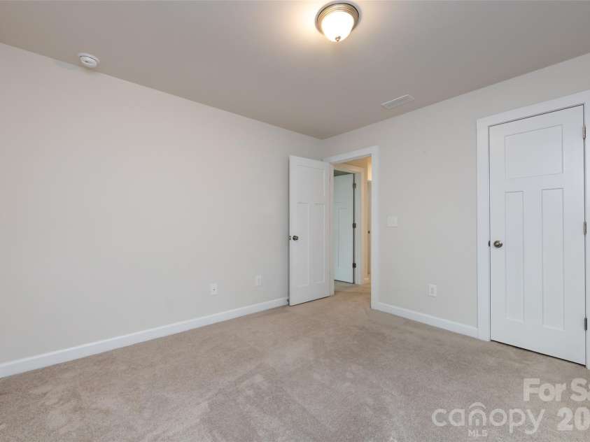11440 Westbranch Parkway, Davidson, NC 28036.  MLS# CAR4366825, YatesRealty ID 20419. Comfortable third bedroom with soft carpeting, natural light, and a versatile layout ideal for guests or a home office.