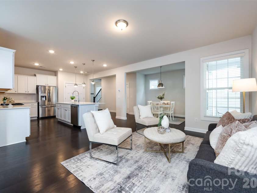 11440 Westbranch Parkway, Davidson, NC 28036.  MLS# CAR4366825, YatesRealty ID 20419. Spacious open-concept great room featuring a cozy fireplace, abundant natural light, and seamless flow into the modern kitchen—ideal for entertaining.