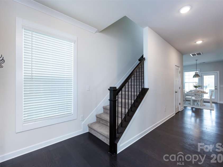 11440 Westbranch Parkway, Davidson, NC 28036.  MLS# CAR4366825, YatesRealty ID 20419. Stairwell to upper level featuring plush carpeting, modern railing, and an open layout that enhances the home’s bright, airy feel.