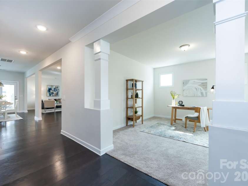 11440 Westbranch Parkway, Davidson, NC 28036.  MLS# CAR4366825, YatesRealty ID 20419. Welcoming entryway opens to a versatile office space framed by elegant columns, offering a bright and functional work-from-home area.