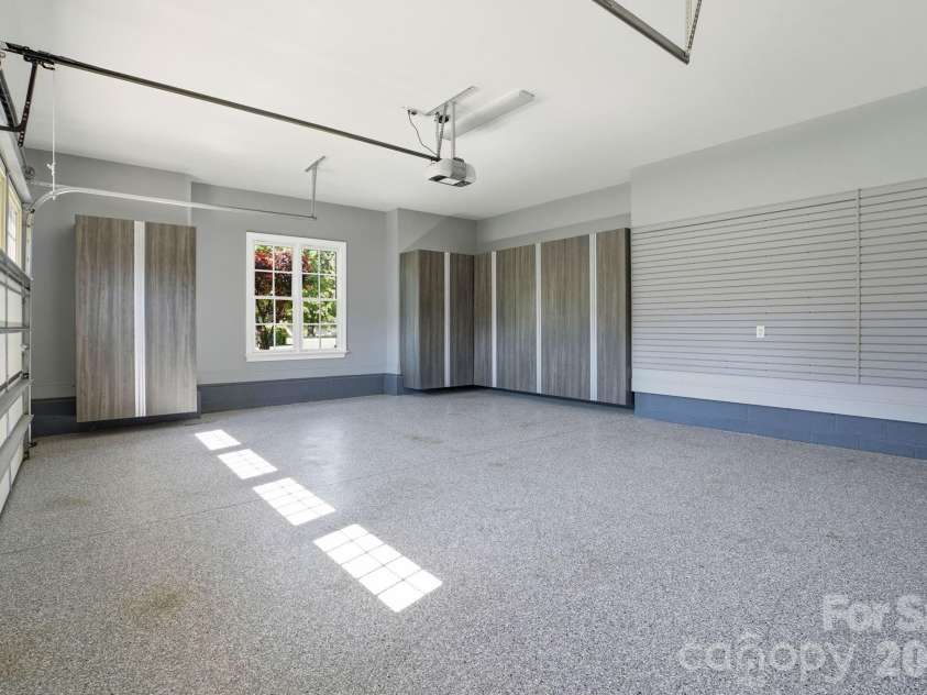 147 Torrence Chapel Road, Mooresville, NC 28117.  MLS# CAR4376776, YatesRealty ID 20424. Clean two stall garage on one side with storage.