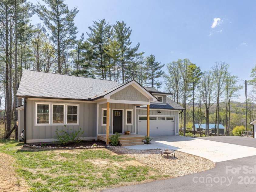 209 Fall Leaves Drive, Fairview, NC 28730.  MLS# CAR4312679, YatesRealty ID 20427. Front of home with 2 car garage.