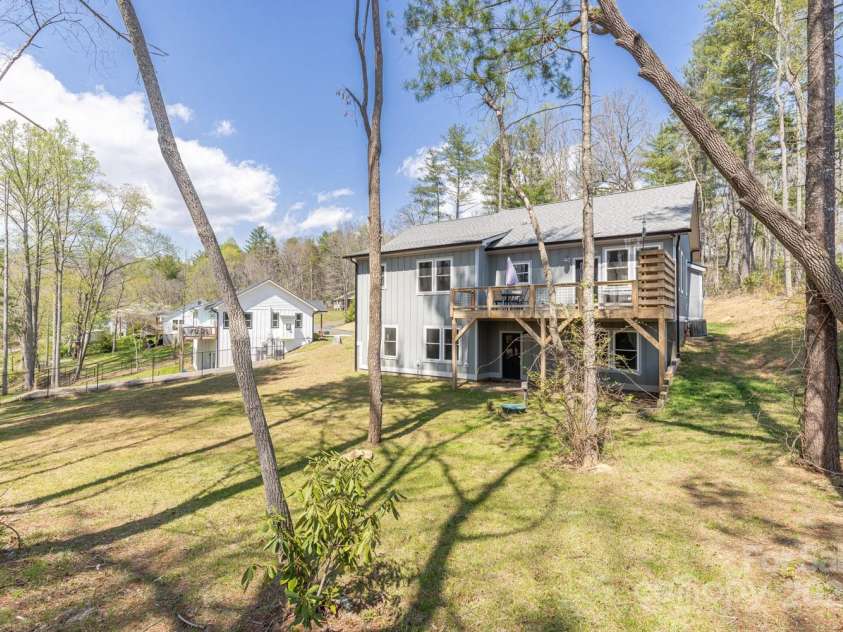 209 Fall Leaves Drive, Fairview, NC 28730.  MLS# CAR4312679, YatesRealty ID 20427. Large gently sloping yard.