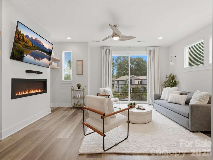 606 West End Drive, Charlotte, NC 28208.  MLS# CAR4369198, YatesRealty ID 20441. Beautiful living room with fireplace insert, TV & mount included, along with juliette balcony