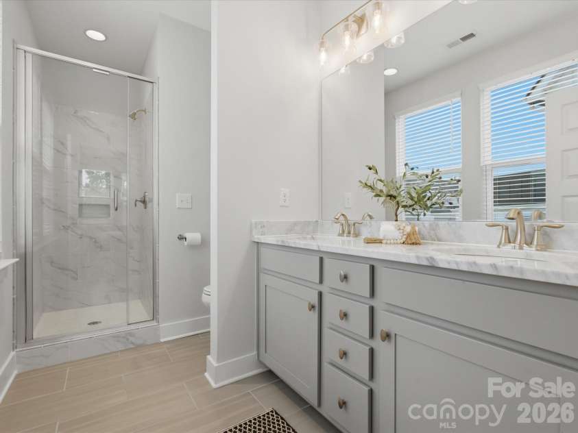 606 West End Drive, Charlotte, NC 28208.  MLS# CAR4369198, YatesRealty ID 20441. Ensuite bath ft. dual vanities & tile shower