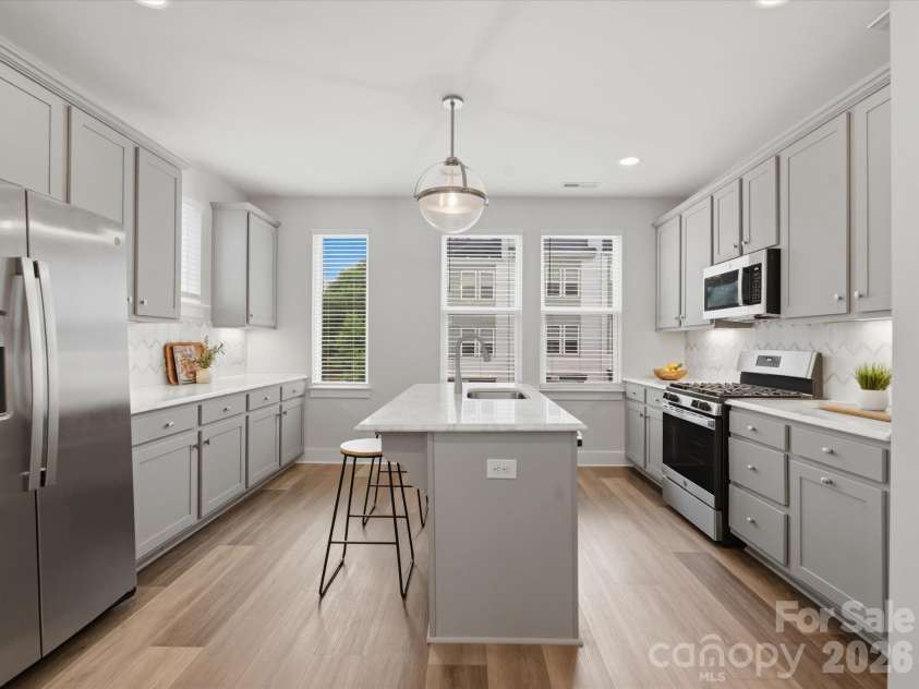 606 West End Drive, Charlotte, NC 28208.  MLS# CAR4369198, YatesRealty ID 20441. Large kitchen with island, upper & lower cabinetry & more WINDOWS 