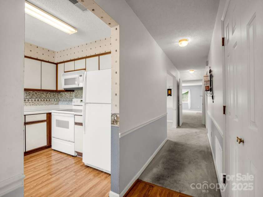 3101 Saint Augustine Place, Asheville, NC 28805.  MLS# CAR4260431, YatesRealty ID 20455. Hallway from kitchen to dining, living and bedrooms.