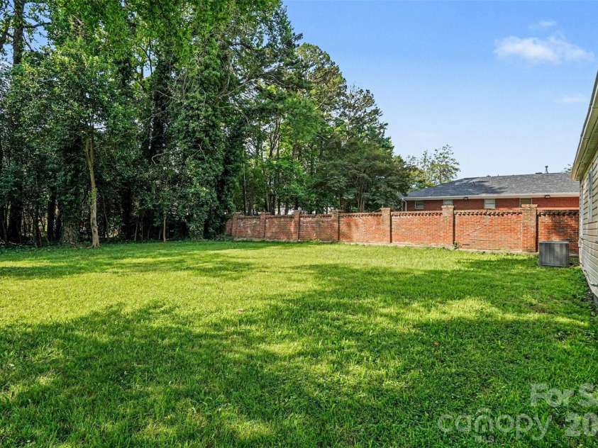 3628 Michigan Avenue, Charlotte, NC 28215.  MLS# CAR4391242, YatesRealty ID 20472. Property line way BEHIND the trees