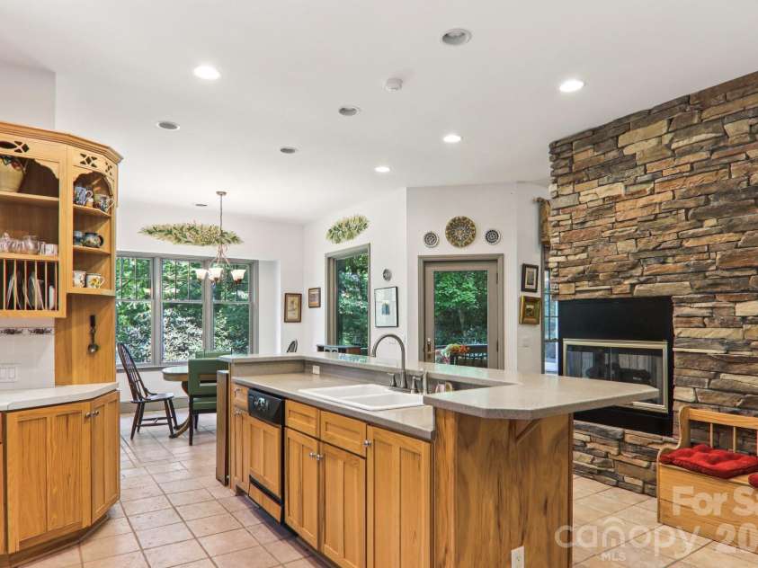1063 Swiss Pine Lake Drive, Spruce Pine, NC 28777.  MLS# CAR4366630, YatesRealty ID 20477. Pass through fireplace warms kitchen and dining area