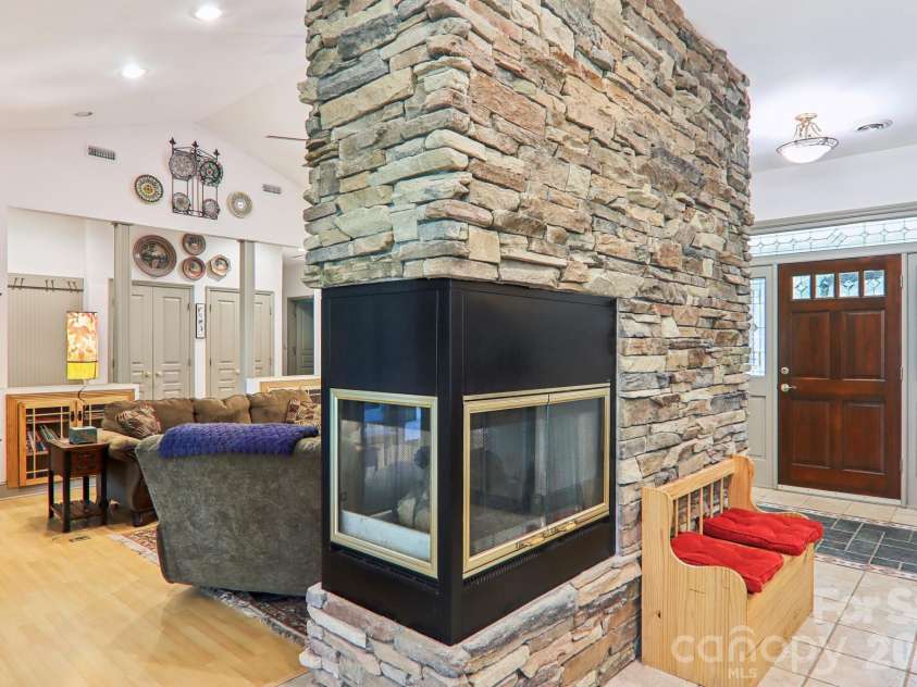 1063 Swiss Pine Lake Drive, Spruce Pine, NC 28777.  MLS# CAR4366630, YatesRealty ID 20477. Stonework with fireplace insert makes an excellent centerpiece