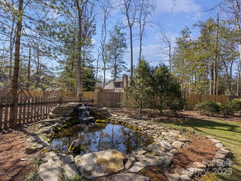 1011 Columbine Road, Asheville, NC 28803.  MLS# CAR4231603, YatesRealty ID 2049. Relax by the koi pond with peaceful waterfall