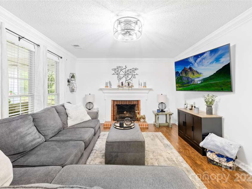 10908 Delsing Court, Charlotte, NC 28214.  MLS# CAR4264464, YatesRealty ID 20504. Living Room with wood-burning fireplace.