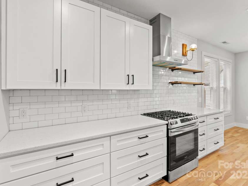83 Talmadge Street, Asheville, NC 28806.  MLS# CAR4269008, YatesRealty ID 20511. Chef's kitchen featuring gas range and a combination of cabinets and open shelving
