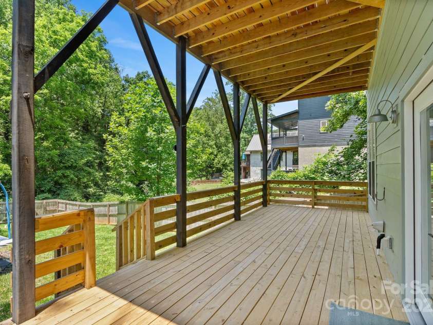 83 Talmadge Street, Asheville, NC 28806.  MLS# CAR4269008, YatesRealty ID 20511. Large lower level deck opens on to fenced backyard