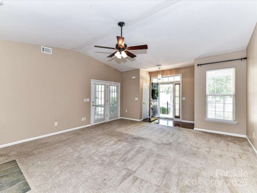 10727 Ryan Courtney Square, Mint Hill, NC 28227.  MLS# CAR4252287, YatesRealty ID 20546. Expansive great room showcases a cozy fireplace, abundant natural light, and seamless flow into the glass-enclosed porch. Open to the kitchen, it's the perfect space for relaxing or entertaining