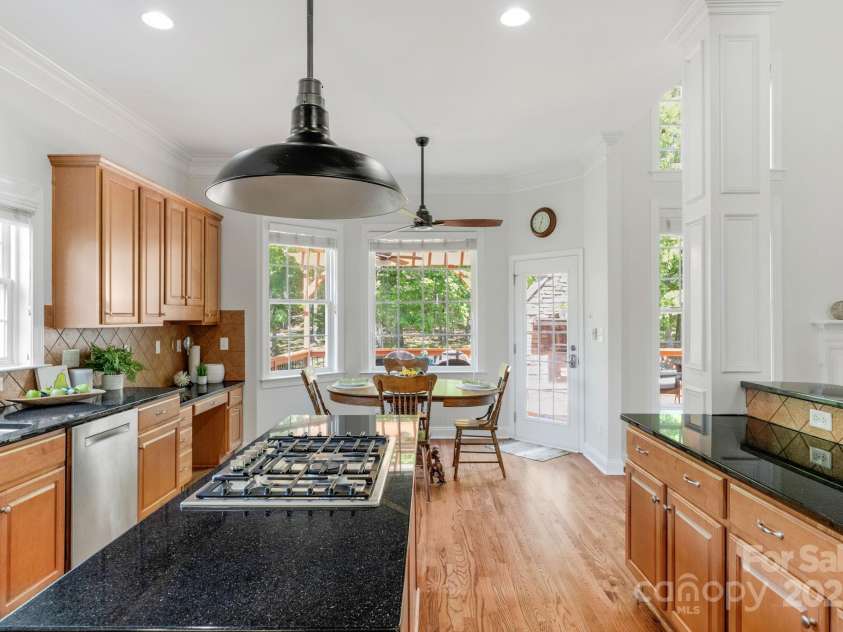 3017 Chisholm Court, Waxhaw, NC 28173.  MLS# CAR4234747, YatesRealty ID 20561. Chef's kitchen with sunny dining area, granite countertops, Bosch appliances, gas cooktop, wall oven and expansive island!