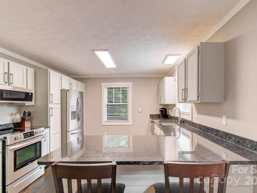 180 Ellerslie Acre None, Hendersonville, NC 28739.  MLS# CAR4270552, YatesRealty ID 20594. Kitchen of 2nd living quarters