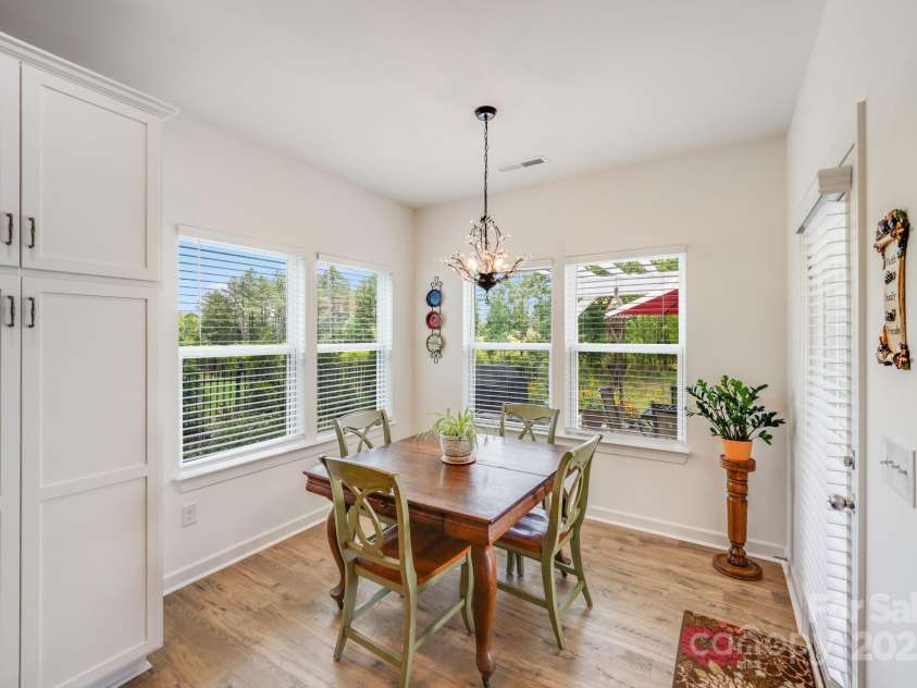 1391 Links Crossing Drive, Monroe, NC 28112.  MLS# CAR4270934, YatesRealty ID 20595. Charming breakfast nook featuring corner windows and a glass patio door that fill the space with natural light and provide easy access to the amazing backyard retreat.