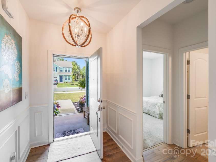 1391 Links Crossing Drive, Monroe, NC 28112.  MLS# CAR4270934, YatesRealty ID 20595. View from the foyer looking out the front door, showcasing the elegant entryway details and a glimpse of the inviting front landscape.