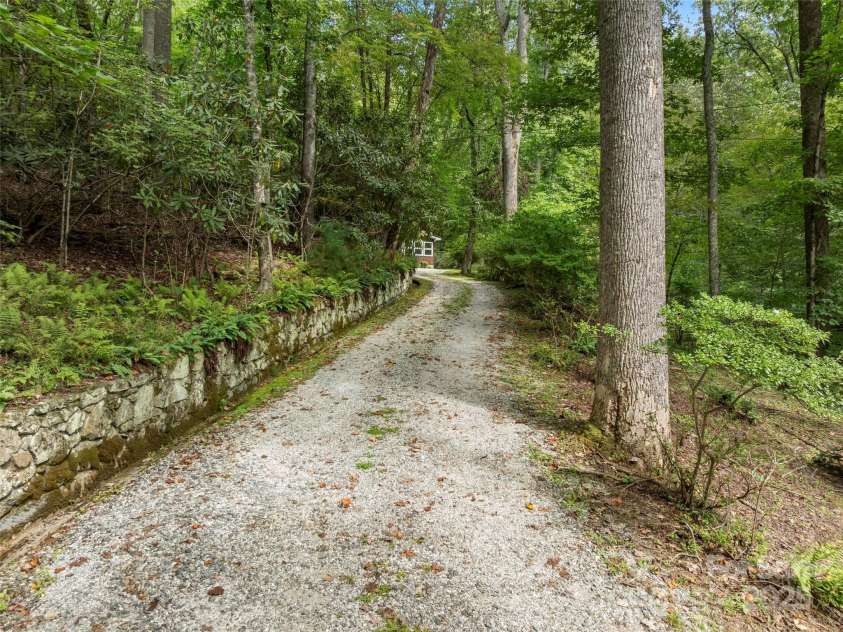 812 Crab Creek Road, Hendersonville, NC 28739.  MLS# CAR4313649, YatesRealty ID 206. Idyllic drive with stone retaining wall