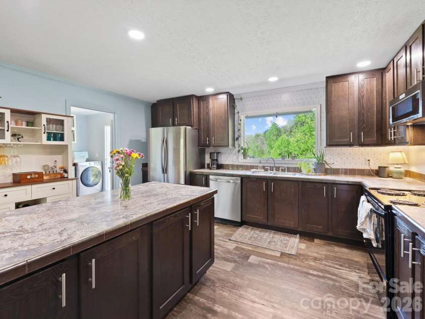 191 Posey Griffin Drive, Mars Hill, NC 28754.  MLS# CAR4374358, YatesRealty ID 20601. Looking back towards the utility/mud room from the kitchen near the dining room.