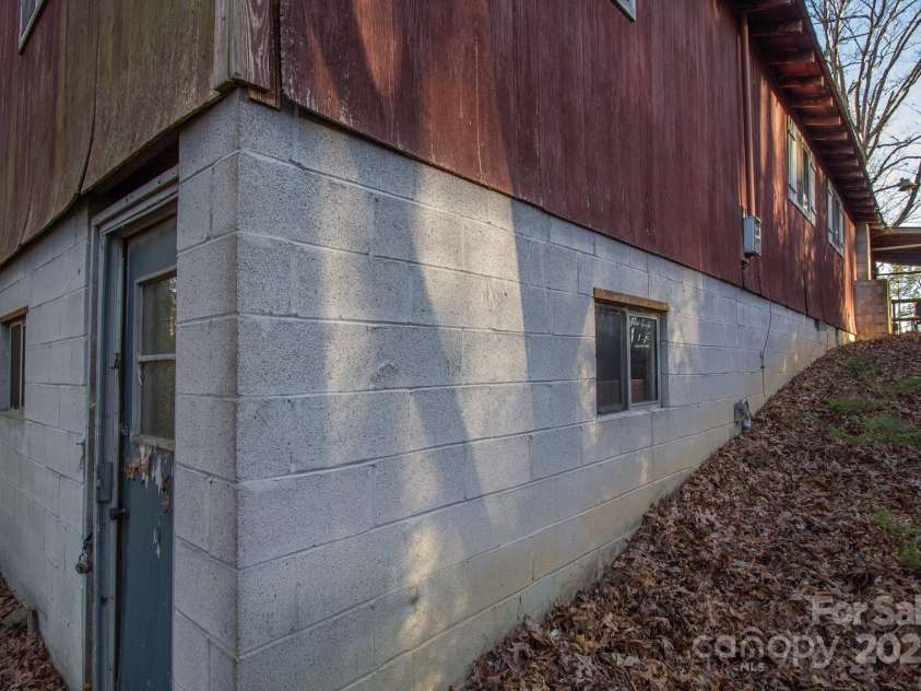 691 Sandy Bottom Road, Marshall, NC 28753.  MLS# CAR4272745, YatesRealty ID 20602. Basement Door and Front side