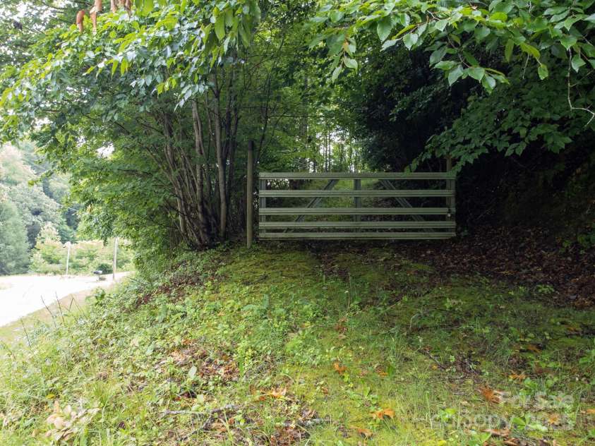 691 Sandy Bottom Road, Marshall, NC 28753.  MLS# CAR4272745, YatesRealty ID 20602. Gate to access road