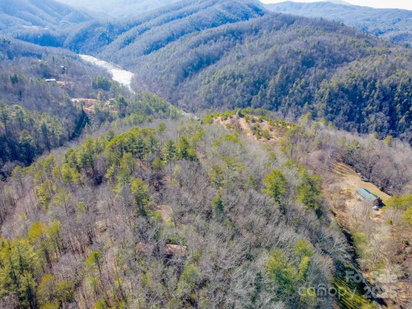 691 Sandy Bottom Road, Marshall, NC 28753.  MLS# CAR4272745, YatesRealty ID 20602. Winter Drone shot of home and French Broad River