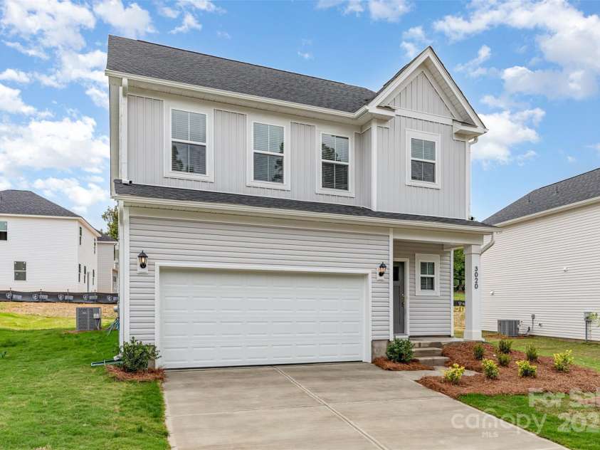 3005 Sadler Woods Lane, Charlotte, NC 28214.  MLS# CAR4272757, YatesRealty ID 20616. Double-car garage & concrete driveway. Representational Photo