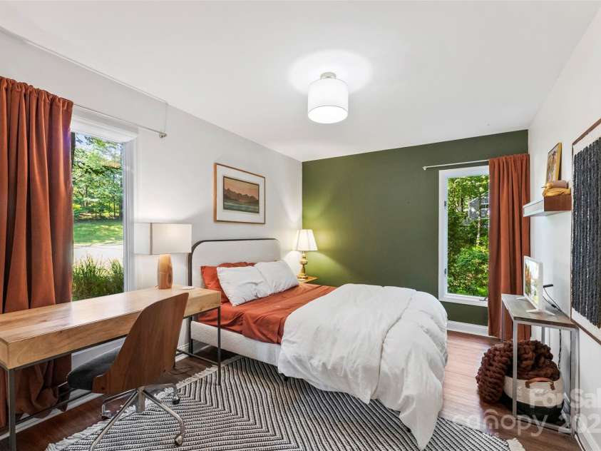 50 Honeysuckle Woods, Lake Wylie, SC 29710.  MLS# CAR4254838, YatesRealty ID 20638. Cozy bedroom in lower level is the perfect guest space offering comfort and privacy