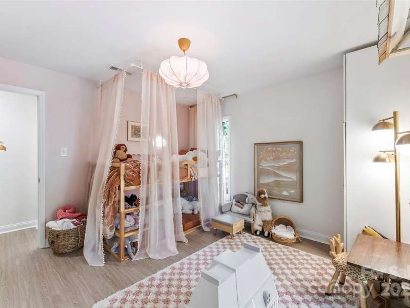 50 Honeysuckle Woods, Lake Wylie, SC 29710.  MLS# CAR4254838, YatesRealty ID 20638. Light filled bedroom with built in cabinetry and wardrobes