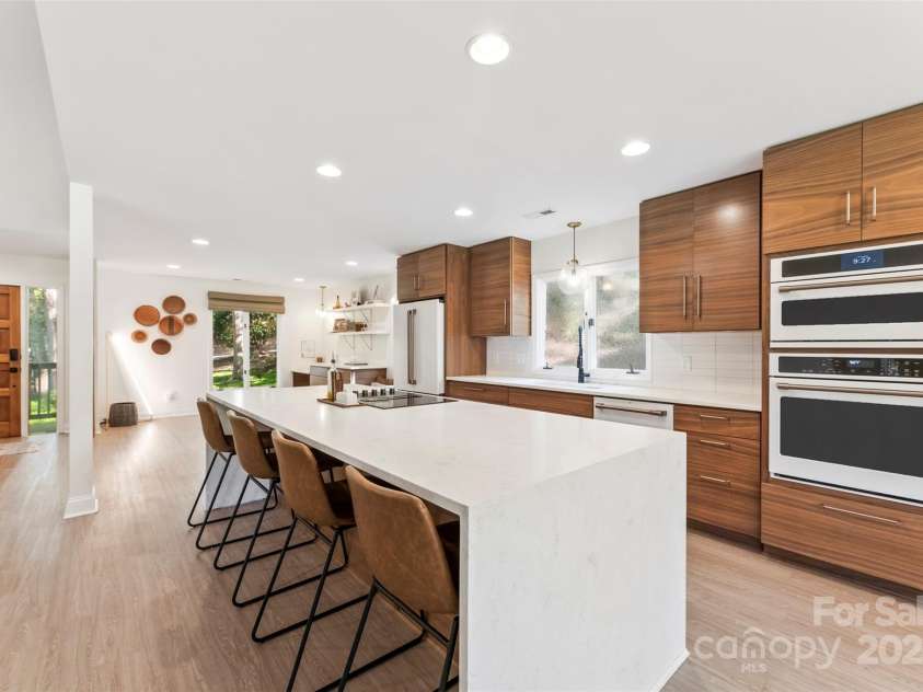 50 Honeysuckle Woods, Lake Wylie, SC 29710.  MLS# CAR4254838, YatesRealty ID 20638. Waterfall island compliments the walnut cabinetry
