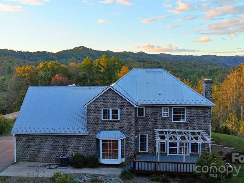 235 Petersburg View Drive, Marshall, NC 28753.  MLS# CAR4308735, YatesRealty ID 2064. Back of the home at dusk.
