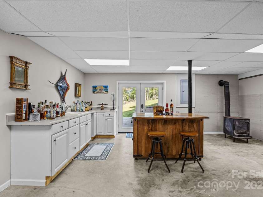 235 Petersburg View Drive, Marshall, NC 28753.  MLS# CAR4308735, YatesRealty ID 2064. Finished basement with wet bar and woodstove