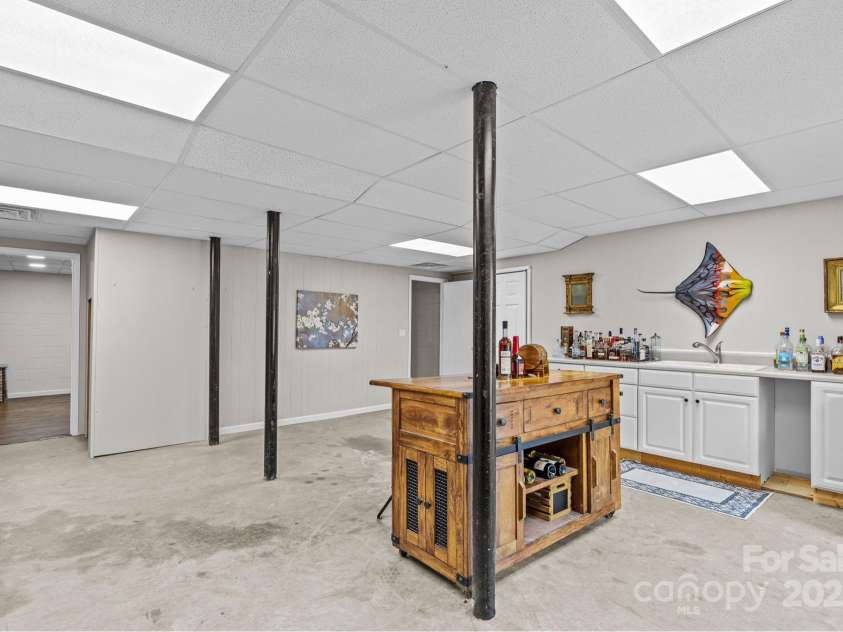 235 Petersburg View Drive, Marshall, NC 28753.  MLS# CAR4308735, YatesRealty ID 2064. Finished basement with wet bar and woodstove